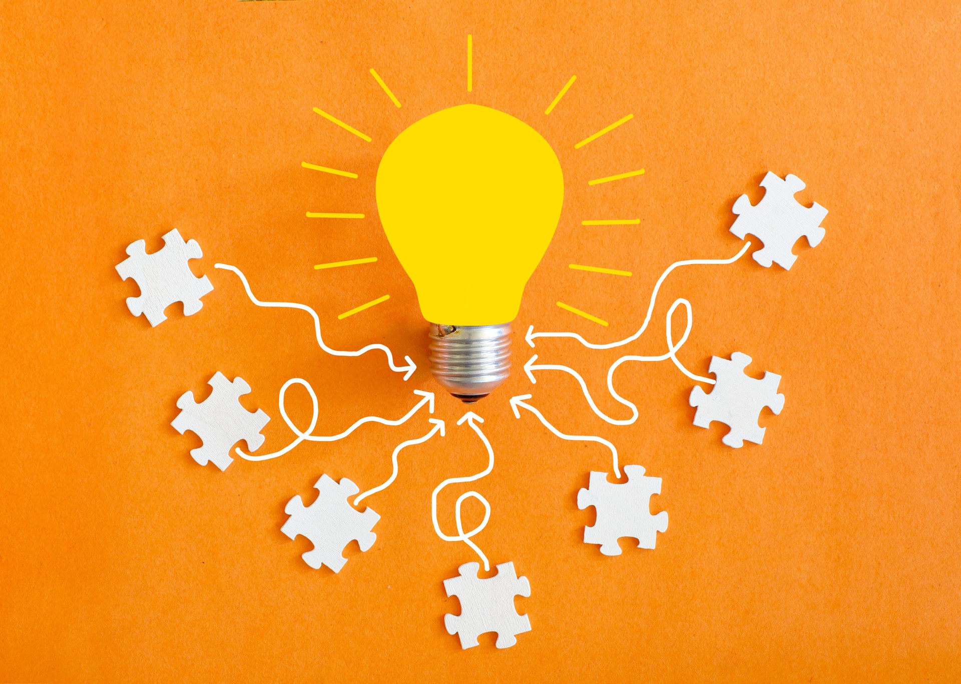 Business concept,collaboration,cooperation,teamwork, innovation,human resources,recruitment,team building with jigsaw puzzle pieces and lightbulb