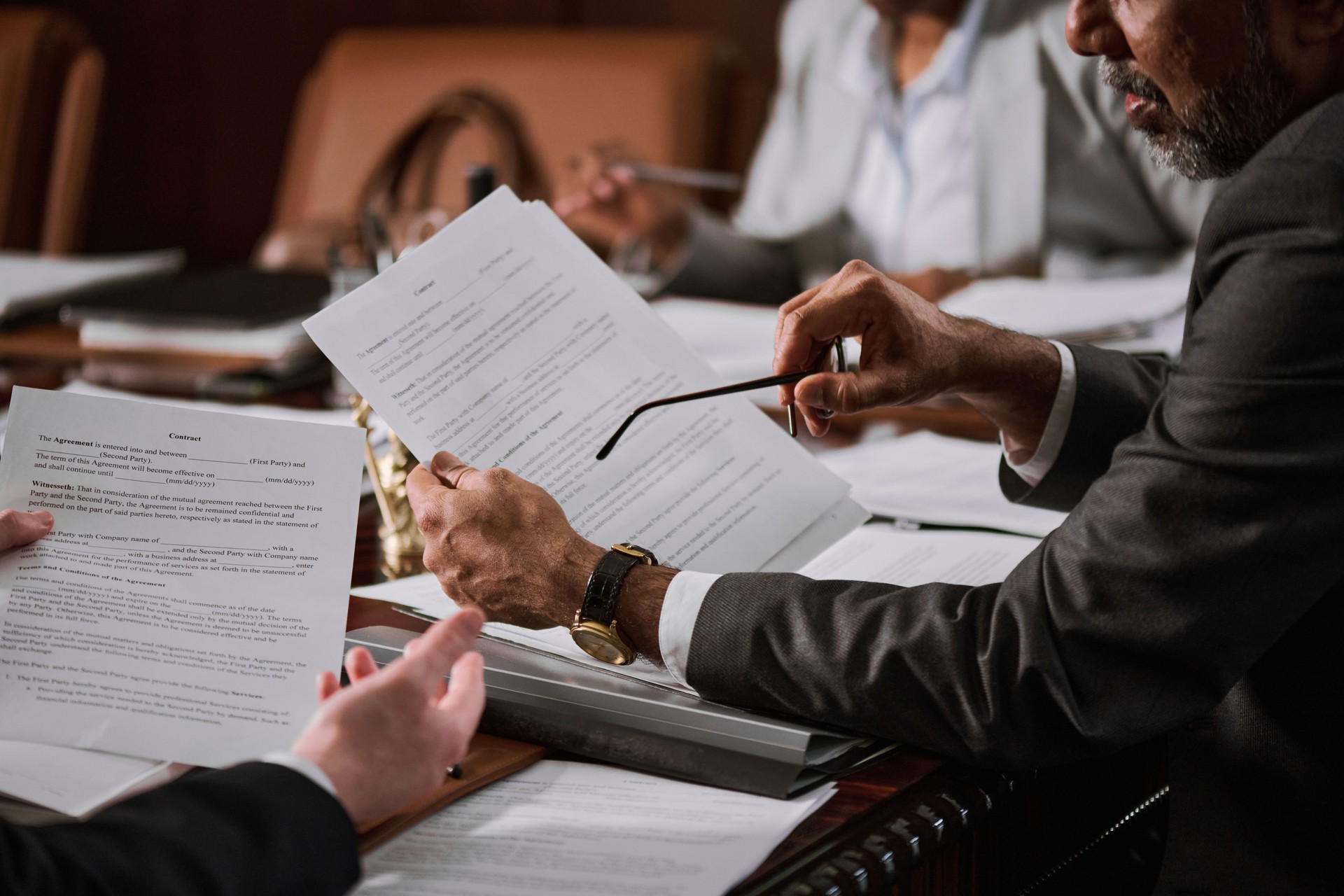 Business professionals reviewing documents in a client-focused consulting discussion